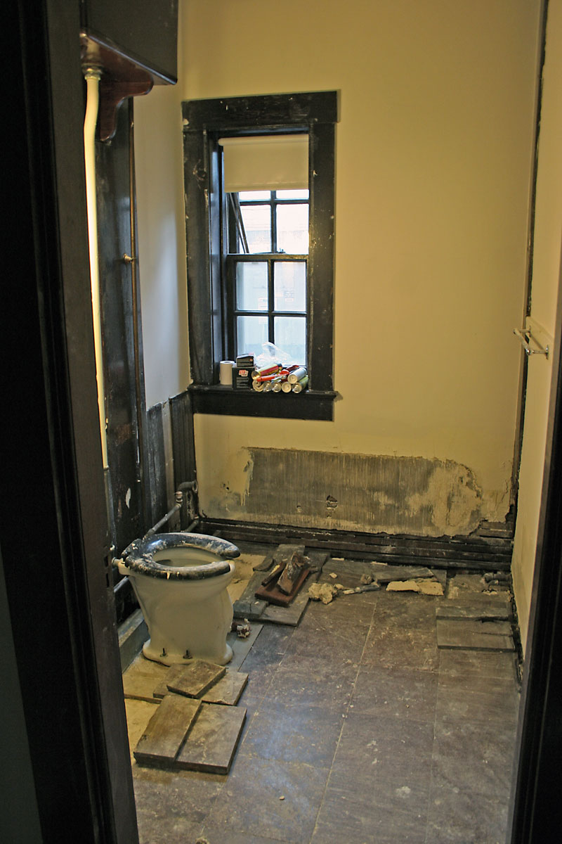 The bathroom minus the tub. Once removed it was discovered that there was substantial water damage to the floor, and many of the original granite tiles are loose or broken